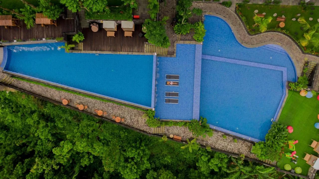 Panoramic pool at Amaranta Prambanan with Mount Merapi and Prambanan Temple views